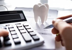 A patient calculating the cost of dentures		