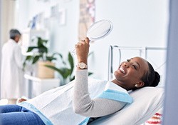 Woman smiling while looking at reflection in mirror