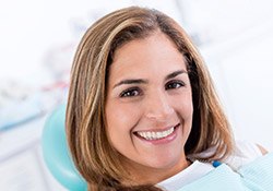 Lady in dental chair happily smiling