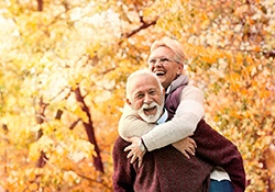 An older man and woman enjoying life and smiling