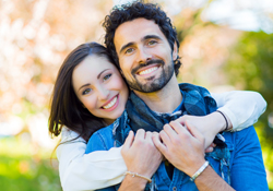 Intimate couple holding each other smiling