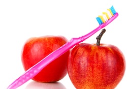 Two apples and a toothbrush