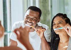 couple brushing their teeth 