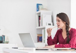 a person chewing on a pen