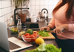 Woman chopping vegetables in kitchen