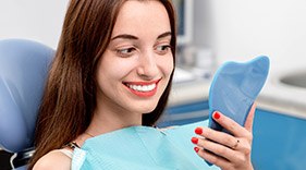 Satisfied Lady looking at reflection in mirror