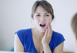 Woman touching her jaw in pain