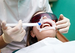 dentist applying whitening gel in the dental office