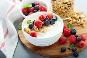 bowl of yogurt with fruit and granola 