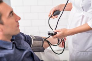 man getting blood pressure taken