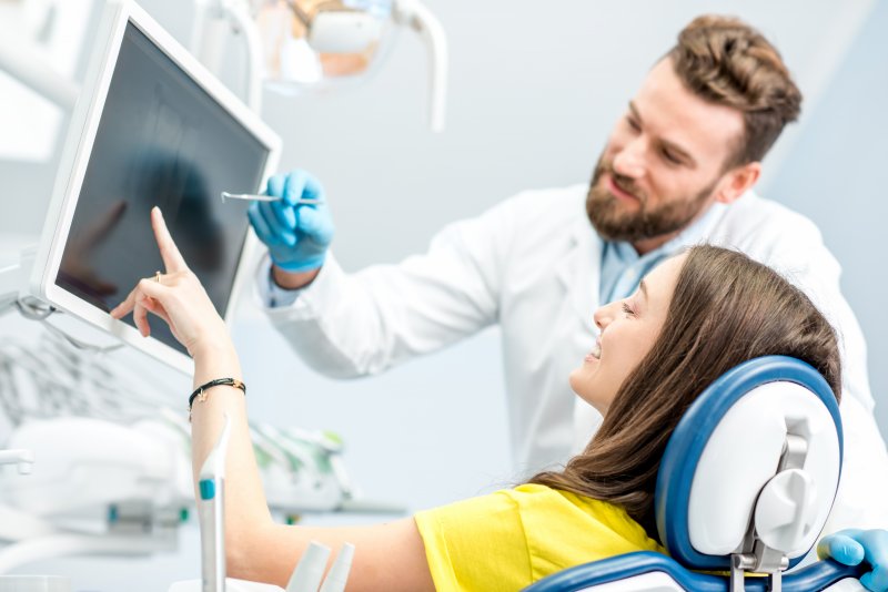 patient speaking to dentist after oral cancer screening