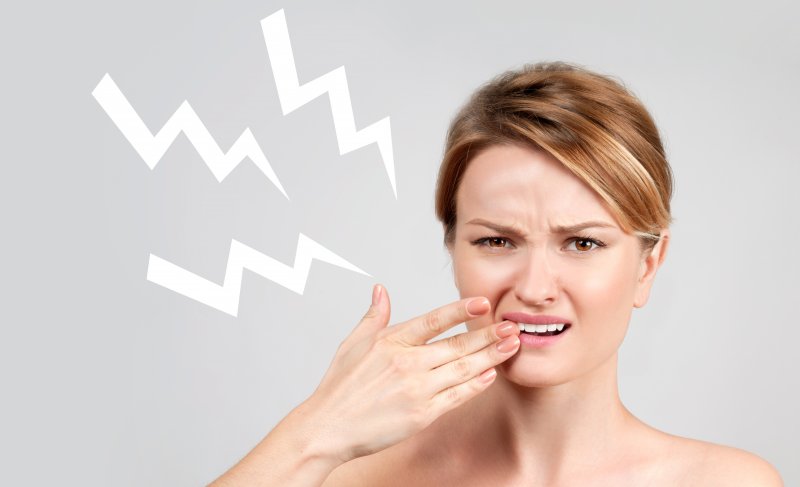 A woman experiencing tooth sensitivity