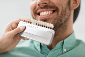 a man smiling while getting veneers