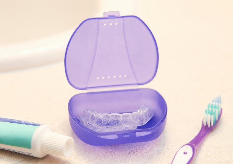 Clear aligner in a purple case