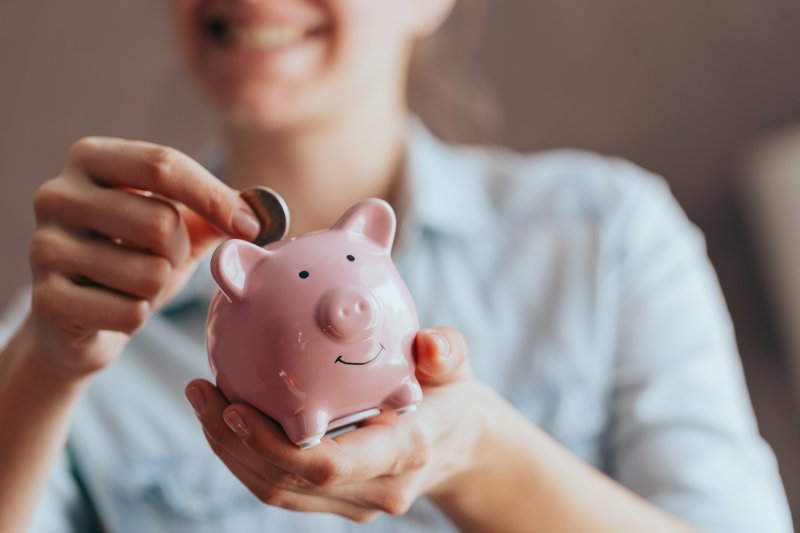a person saving coins in a piggy bank