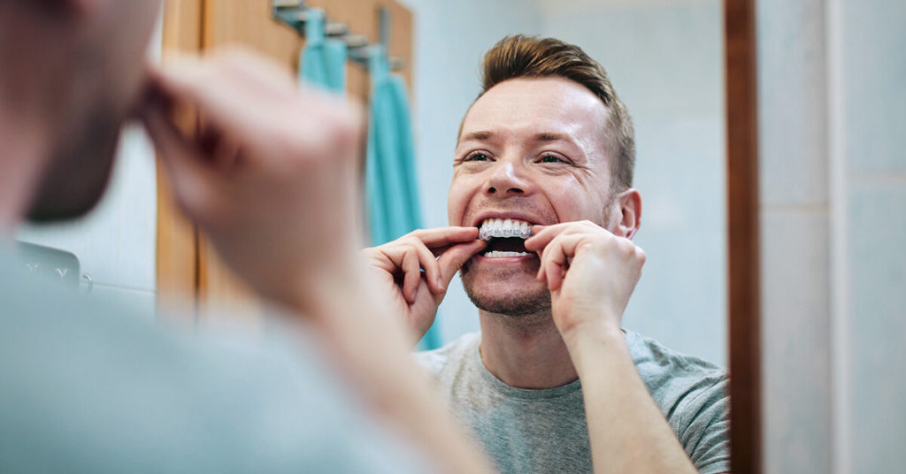 person using store-bought teeth whitening products 