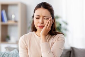 Woman experiencing pain in jaw.